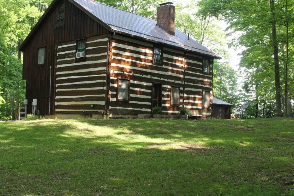 1800's log cabin with board and batten