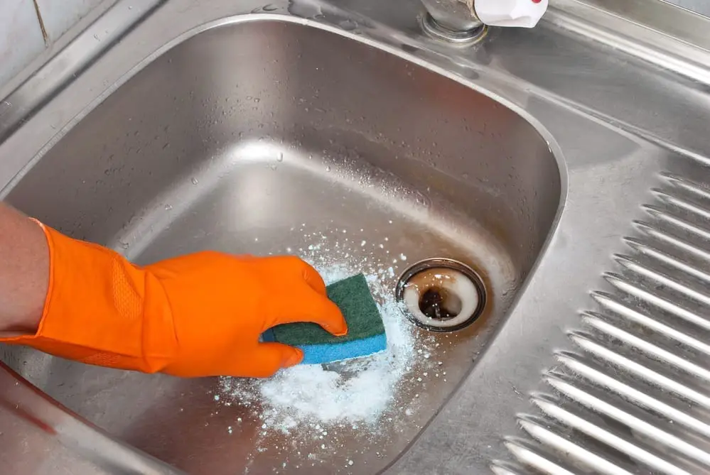 Cleaning the kitchen sink.