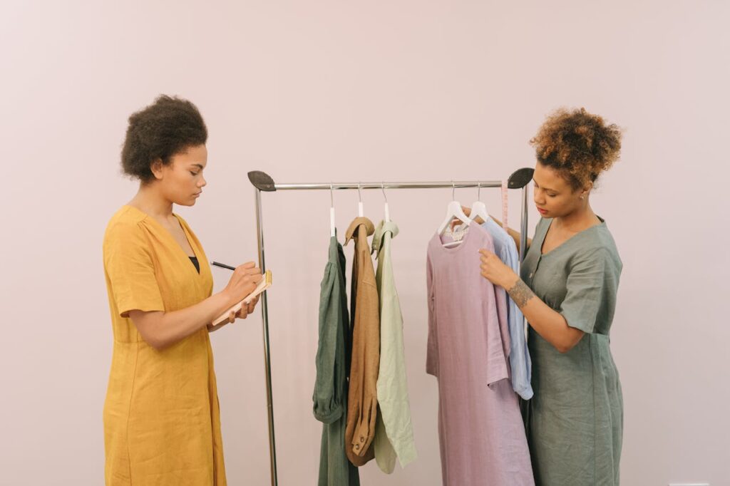 Two women looking through a rack of professional clothing
