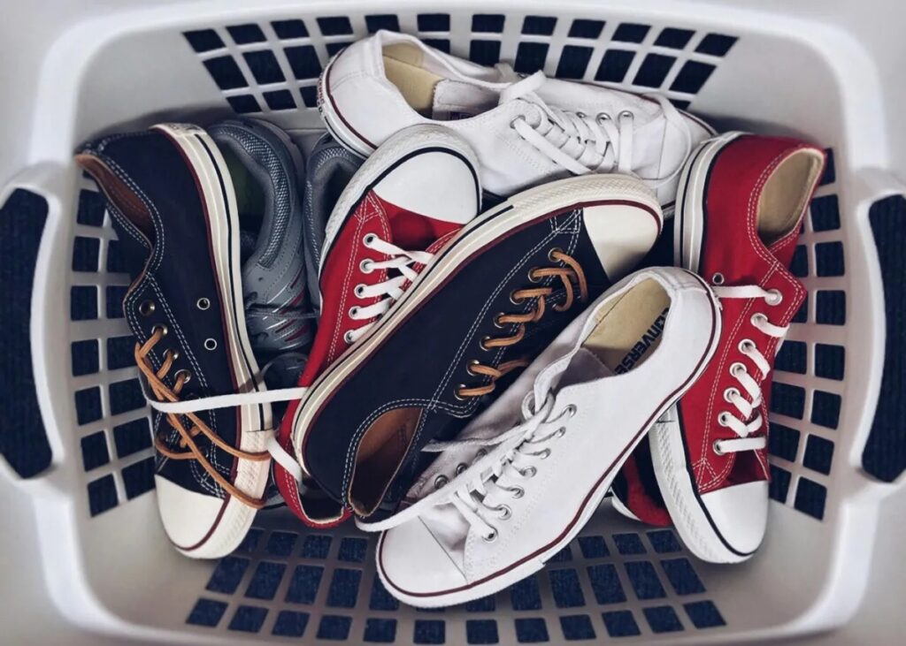 A laundry basket full of sneakers