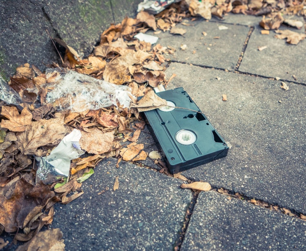 A vhs tape thrown on sidewalk