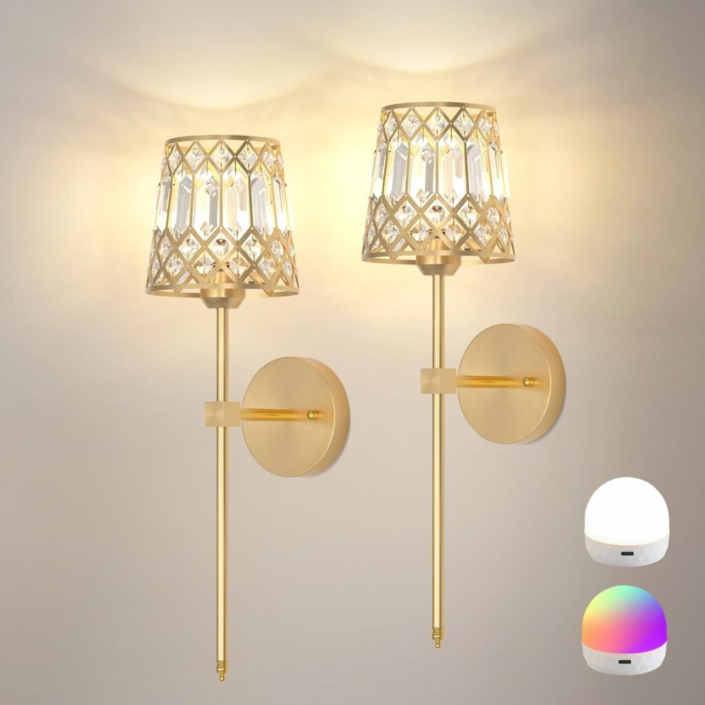 Set of two gold battery operated wall sconces on wall