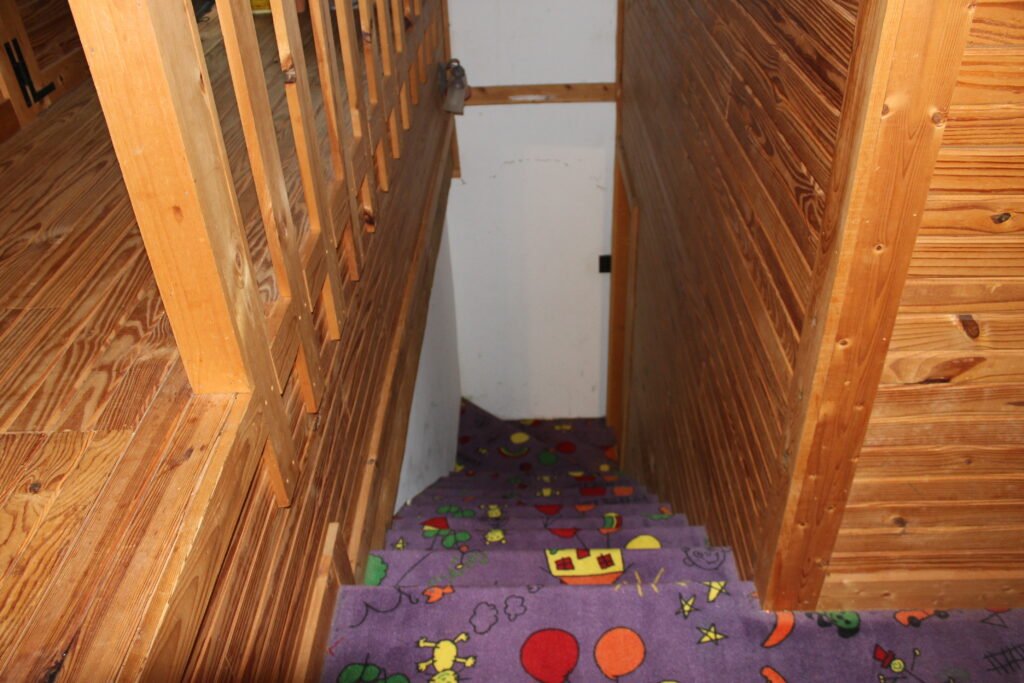 An attic with horizontal pine paneling