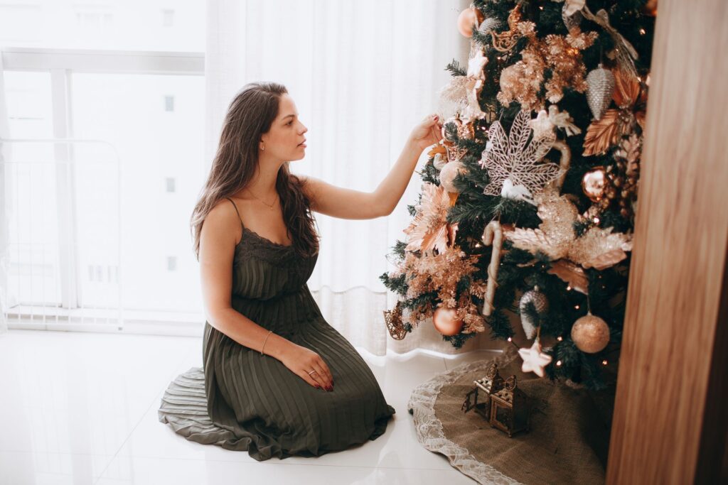 Woman decorating an artificial Christmas tree