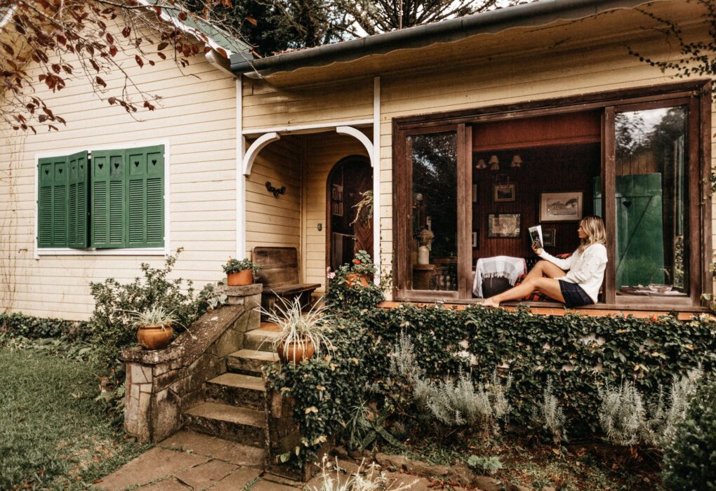 Woman sitting on porch reading