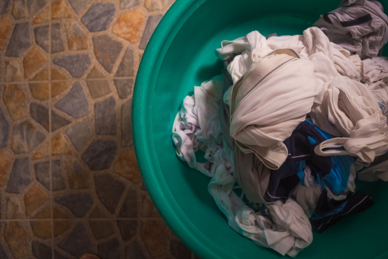 stained clothing in a bucket