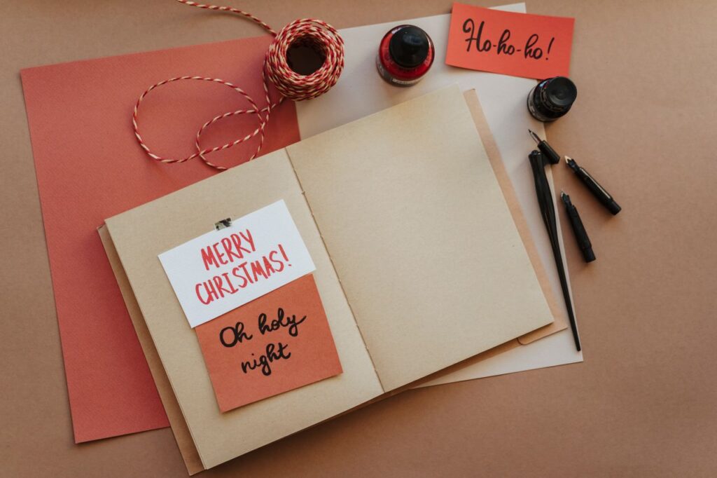Woman crafting with Christmas cards and twine