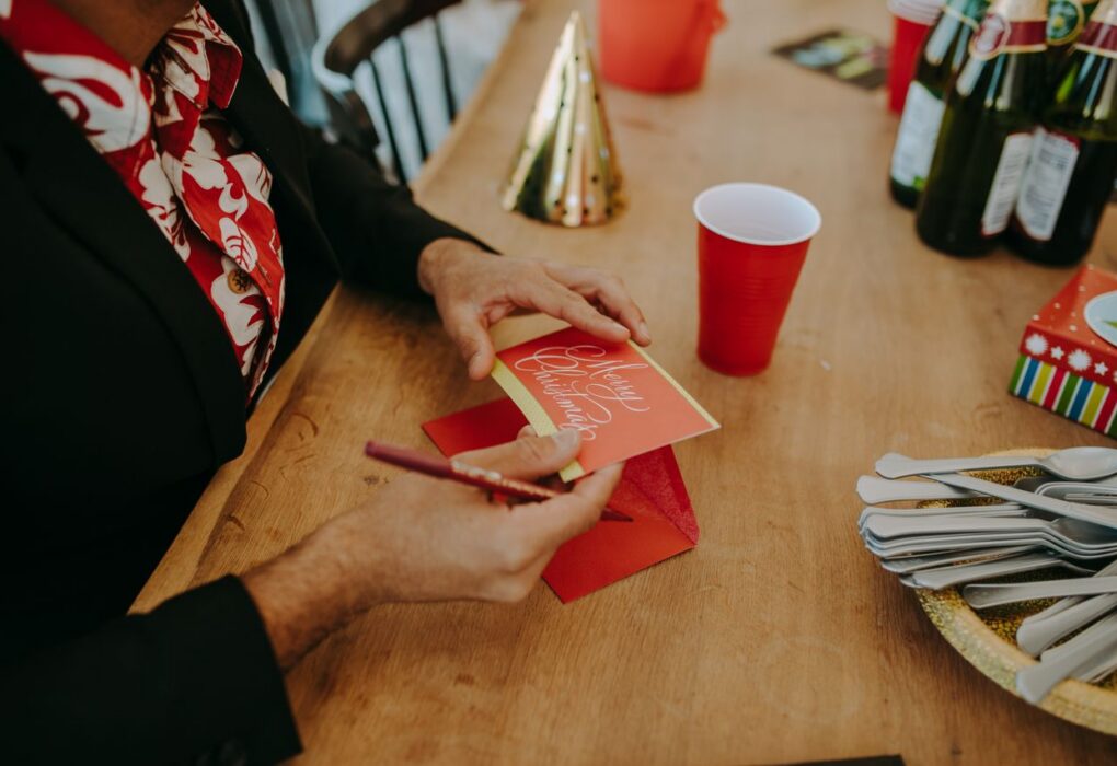 Woman writing on Christmas card