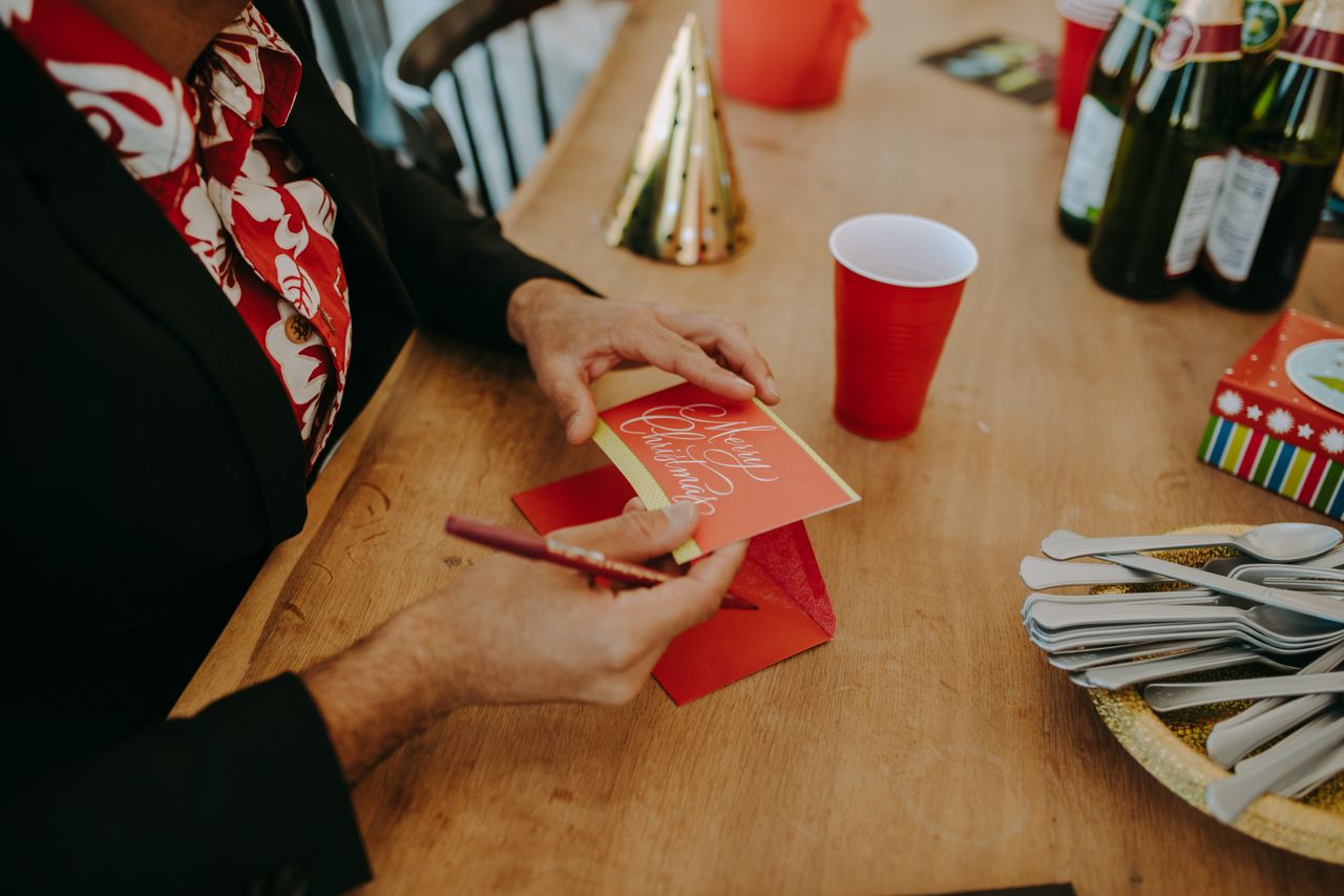 Woman writing on Christmas card
