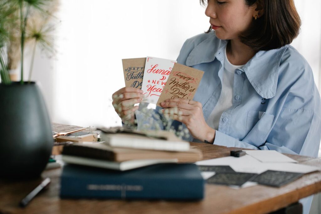 Woman holding stack of greeting cards